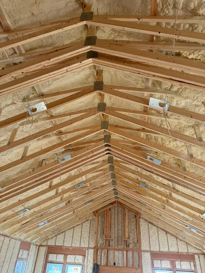 Finished spray foam insulation between residential roof rafters