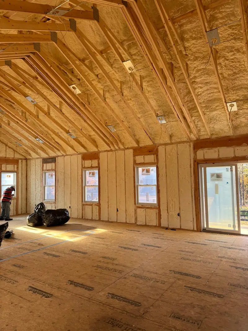 Finished spray foam insulation across residential walls and the sloped roofline